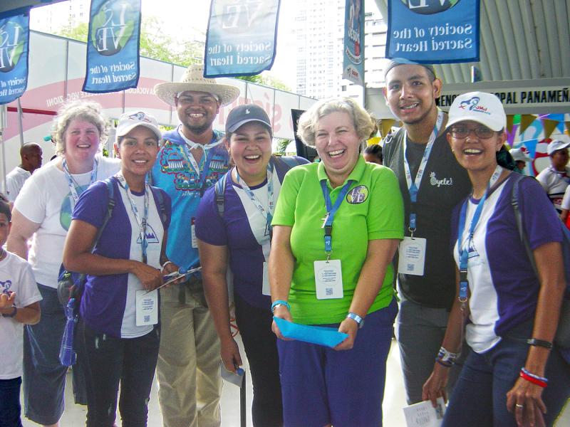 Lisa Buscher, RSCJ, (far left) and Mary Finlayson, RSCJ, (in green) welcoming pilgrims at the Vocation Fair of World Youth Day 2019, Panama. Lisa Buscher, RSCJ, (far left) and Mary Finlayson, RSCJ, (in green) welcoming pilgrims at the Vocation Fair of World Youth Day 2019, Panama.