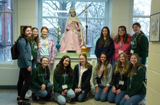 Students pose with the statue of Mater located at the Academy of the Sacred Heart in St. Charles