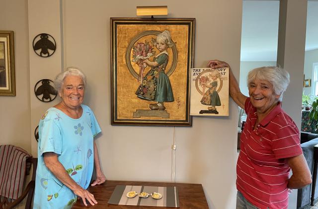 Anne Dyer, RSCJ (left), and Bee Dyer Gonnella(right) pose with an original 1926 Leyendecker Saturday Evening Post illustration